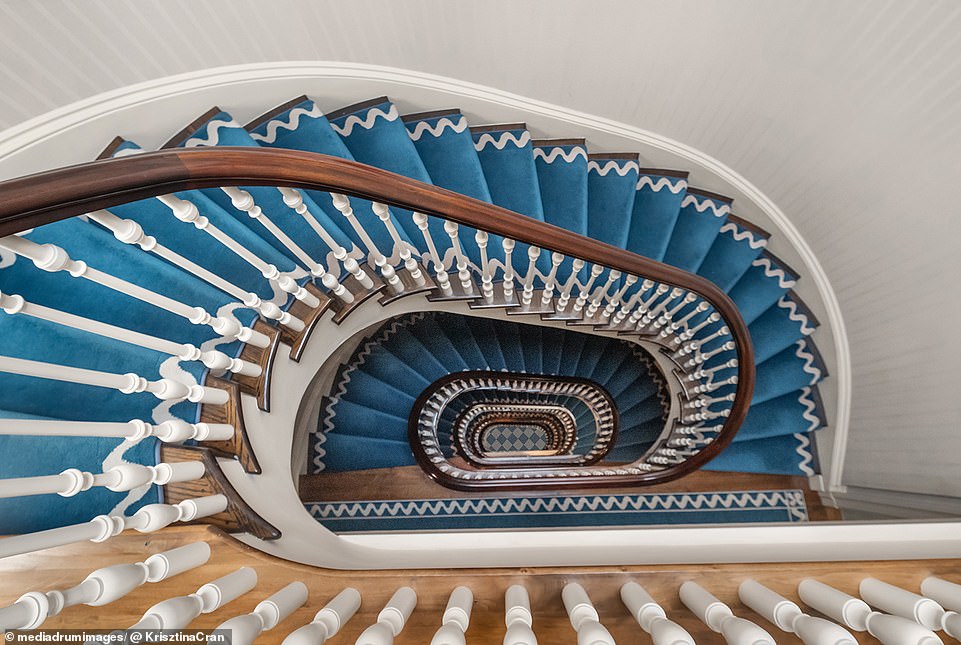 The neo-Italian Renaissance style property features a striking spiral staircase that winds from top to bottom