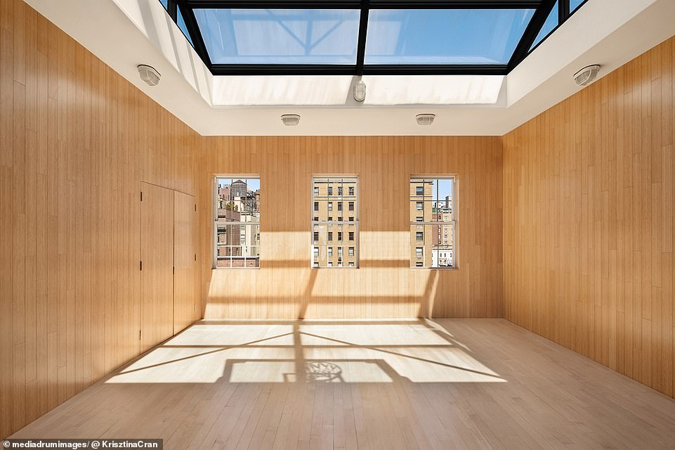 The top floor houses a half basketball court, complete with a plank floor, padded walls and a huge skylight on the ceiling