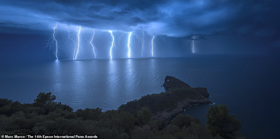 Marc Marco captures the incredible moment several lightning bolts strike the water during an electrical storm off the coast of Sa Foradada in Mallorca, Spain.  The image ranks 28th in the top 50 photos submitted in the Amateur Nature Landscapes category