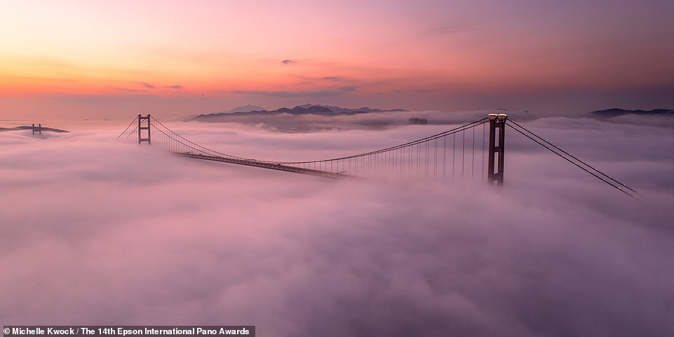 Hong Kong's Tsing Ma Bridge peeks through the clouds in this photo by Michelle Kwock.  It ranks tied for 48th in the Amateur Built Environment category