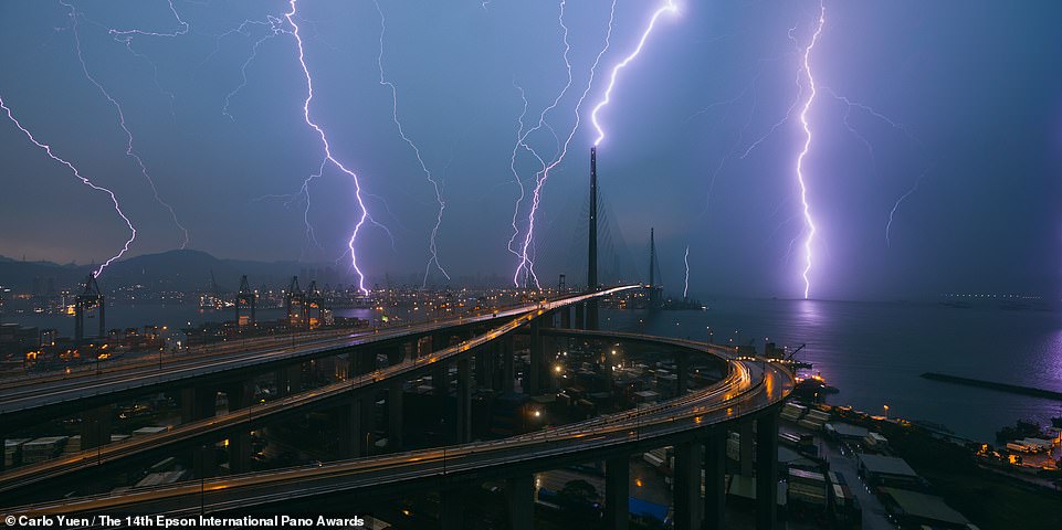 In this dramatic image by Carlo Yuen, purple lightning appears to strike Hong Kong.  It comes in 32nd place in the Open Built Environment category