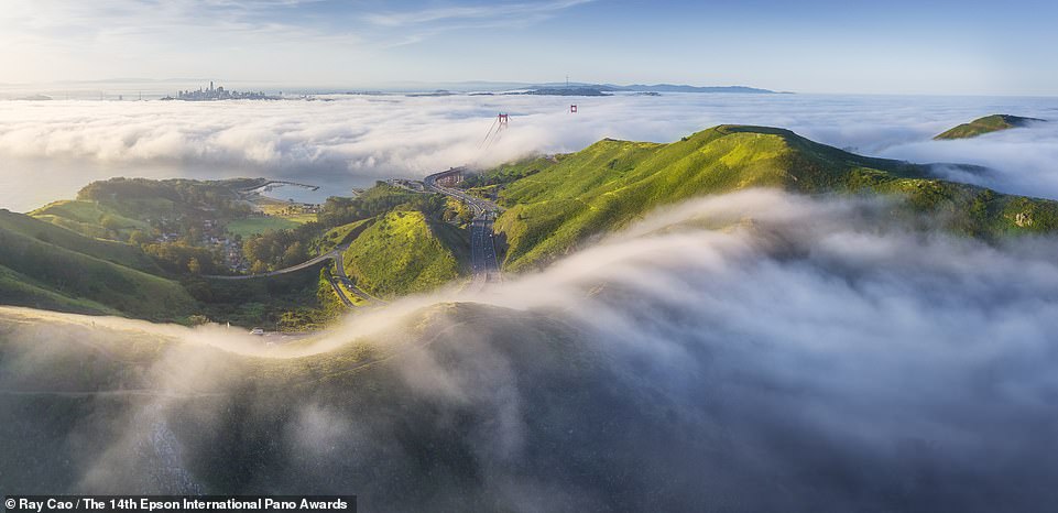 This beautiful photo shows the landscape around San Francisco, with the top of the Golden Gate Bridge emerging from the clouds.  Captured by American photographer Ray Cao, it ranks 18th in the Amateur Built Environment category