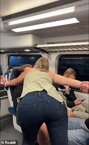 The 'Karen' towers over a group of tourists as they chat with each other in their seats