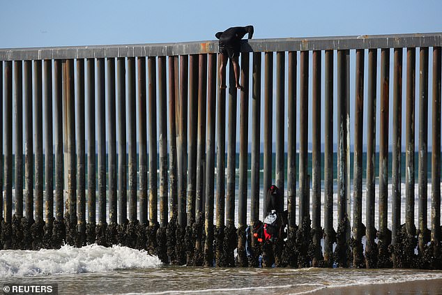 Donald Trump now wants a public apology from President Biden after his sharp reversal this week by resuming construction of the southern border wall in some areas where illegal immigration is increasing.  Pictured: A migrant climbs the border fence to seek asylum after entering the U.S. from Tijuana, Mexico, on October 2, 2023