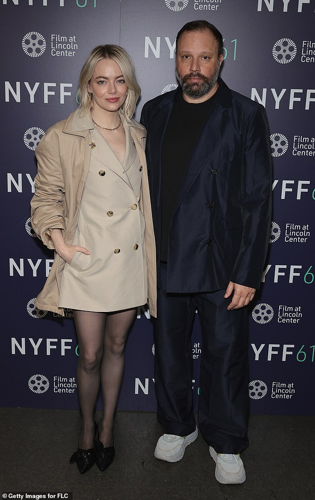 Team: The short frock was designed to mimic a trench coat, and she doubled the look by adding a real trench in a slightly darker khaki shade on top;  pictured with Bleat director Yorgos Lanthimos