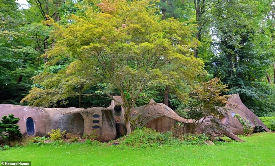 From a distance, the enclosure resembles an odd-looking rock formation, but it is made of concrete and spray foam