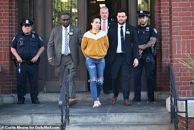 Authorities escort Grei Mendez from a Bronx police station following her arrest in connection with the death of a one-year-old boy who died at her daycare on September 15