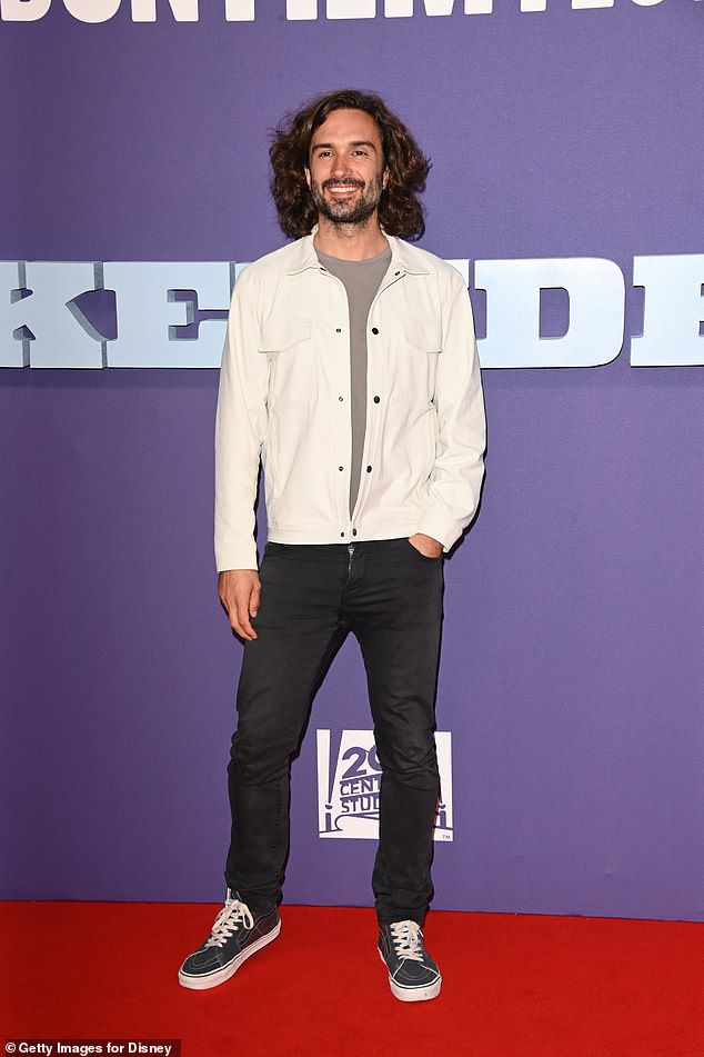 Smile: Joe Wicks opted for a cream jacket and black jeans for the event