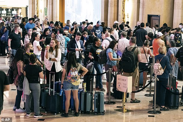 Hotel guests wait in line at check-in at the Luxor hotel and casino in Las Vegas on September 14 after MGM Resorts International suffered a cybersecurity attack