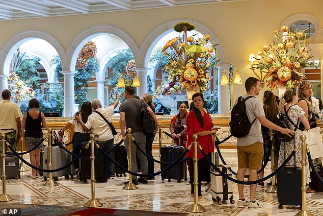 Guests wait to check in at the Bellagio on September 15 in Las Vegas.  The breach disrupted reservation systems and caused annoyance and delays for guests