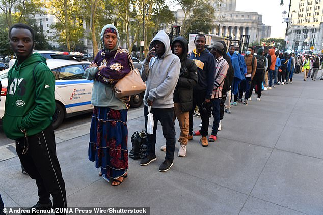 Migrants pour into New York City and line up to enter the Federal Plaza to file with immigration authorities, October 2