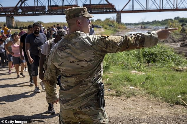 The small town of Eagle Pass, Texas, has become an epicenter of the crisis, with more than 8,000 crossings per week.  The photo shows a Texas National Guard soldier at Eagle Pass on September 28