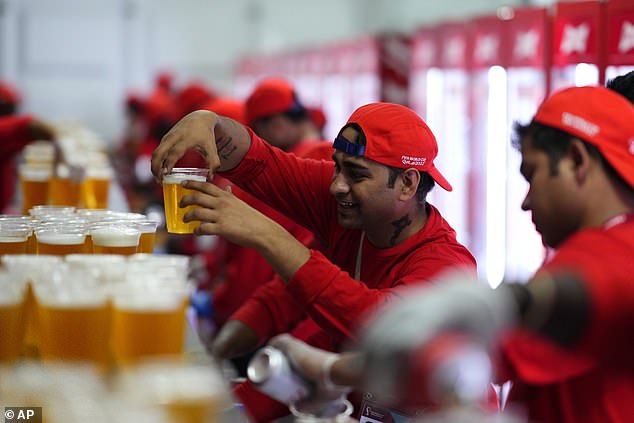 Employee drinks a beer in a fan zone prior to the World Cup in Doha, Qatar, last year