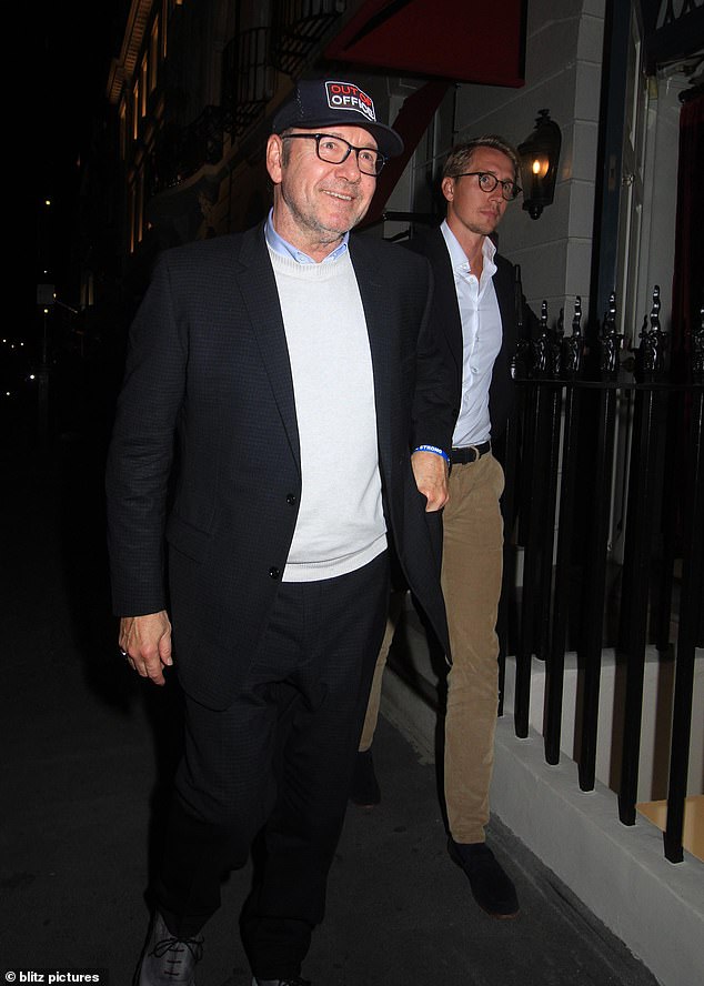 The Oscar winner, 64, looked relaxed as he left the West London venue last night, wearing a suit jacket and baseball cap with the tongue-in-cheek slogan 'out of office'.