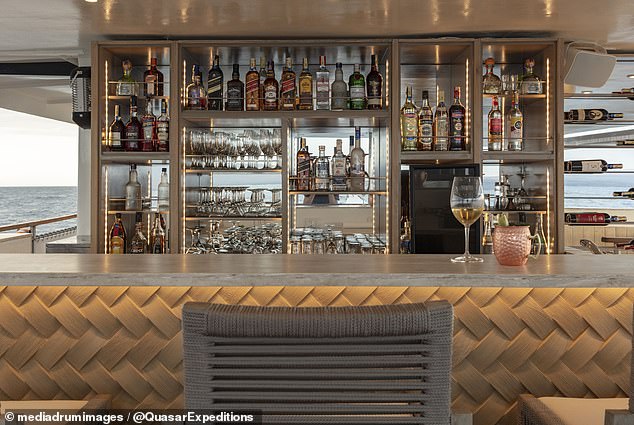 And while you're hanging out, you can even grab a drink at the newly upgraded bar, which features a light gray table, dark gray chairs and gold accents