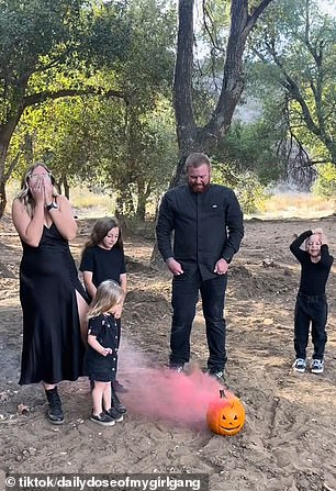 The video begins with Kendra, her husband and her three daughters standing around a Jack-O-Lantern