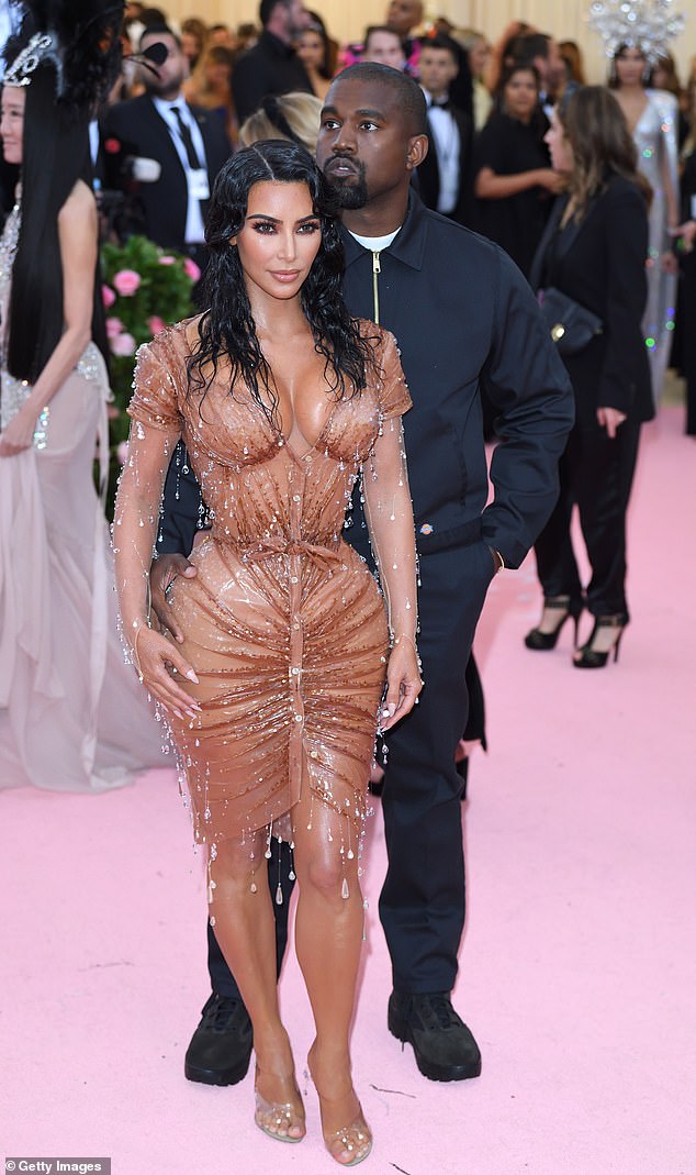 Kim Kardashian in a wet look dress, pictured with Kanye West, at the 2019 Met Gala