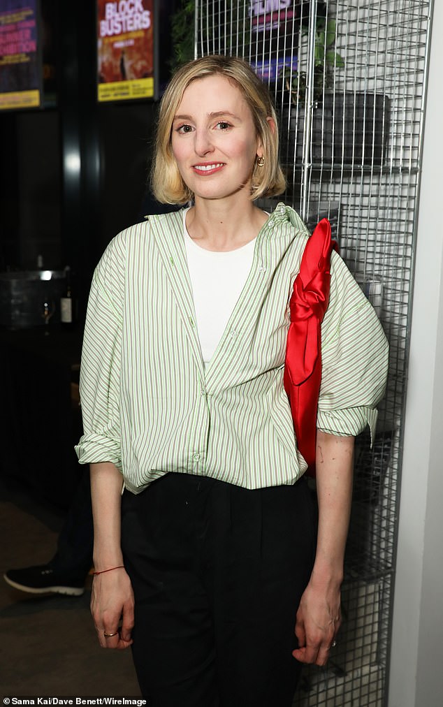 Fashion focus: She wore black pants and carried a bright red handbag in the evening