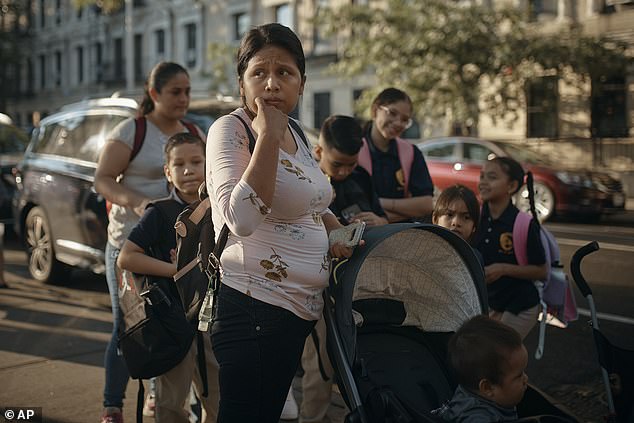 Kimberly Carchipulla, front center, checks on her son Damien's school on Thursday, Sept. 7, 2023, in New York