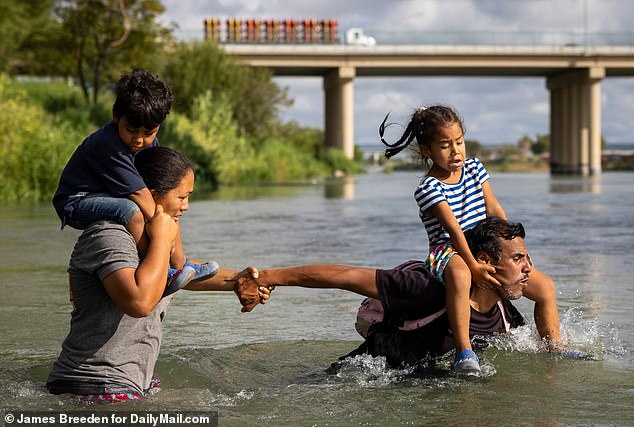 Dramatic photos show the moment migrants cross the Rio Grande River from Piedras Negras, Mexico to Eagle Pass, Texas - which has become the epicenter of border crossings in recent times