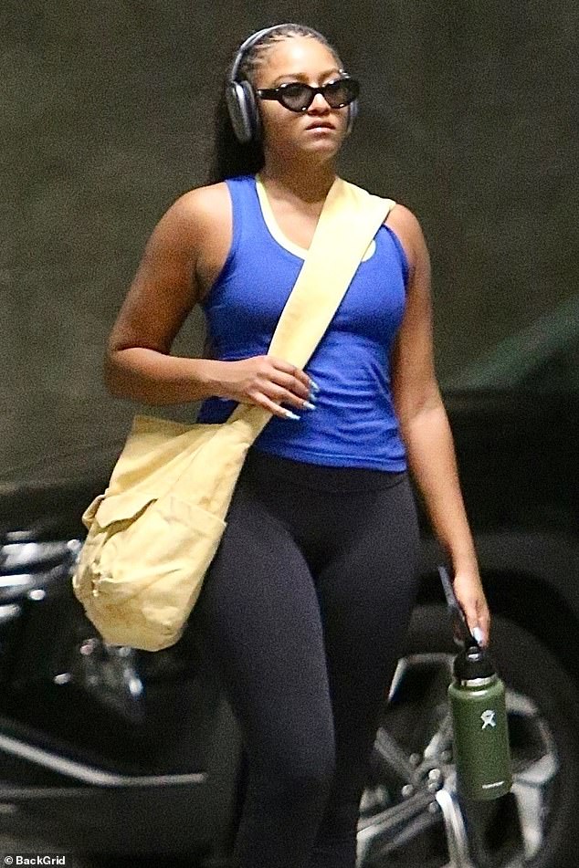 Sasha's pale yellow sports bra could be seen on top of her athletic tank