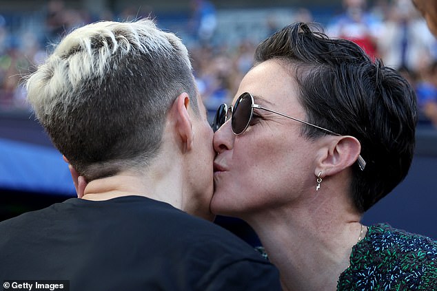 Rapinoe (left) receives a kiss from her twin sister Rachael (right) during her final regular season NWSL home game