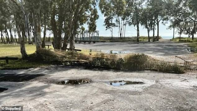 Part of the beach is surrounded by a low mesh fence (pictured), preventing Burrum Heads locals from accessing the beach