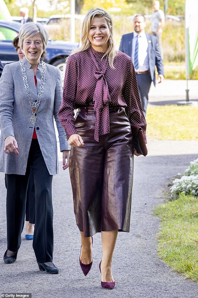 Queen Maxima is perfectly color blocked.  The burgundy leather panties are worn with a pussy bow blouse that instantly makes the outfit more feminine