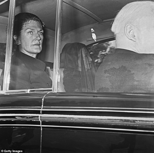 Pictured: Wallis, centre, is led to the funeral of her husband, the Duke of Windsor, in 1972