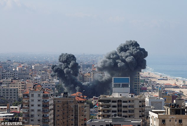 Smoke billows from a building in Gaza after Israel fired missiles in response to Palestinian airstrikes earlier Saturday