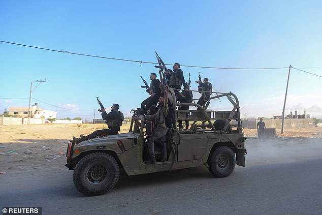 Men believed to be Palestinian militants are seen driving an Israeli military vehicle after allegedly seizing it near the border between Israel and the Gaza Strip