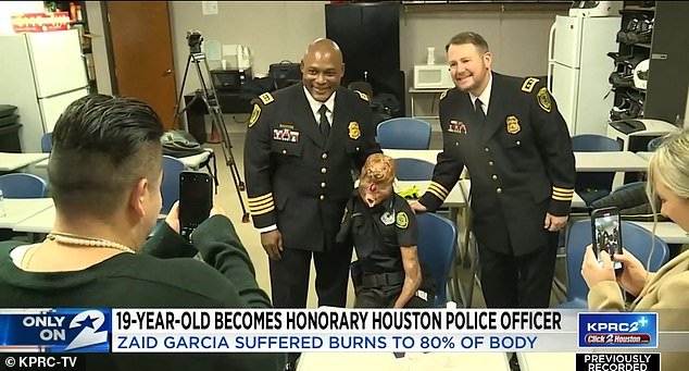 Above he is seen with the troop's boss, Troy Finner, posing for a photo