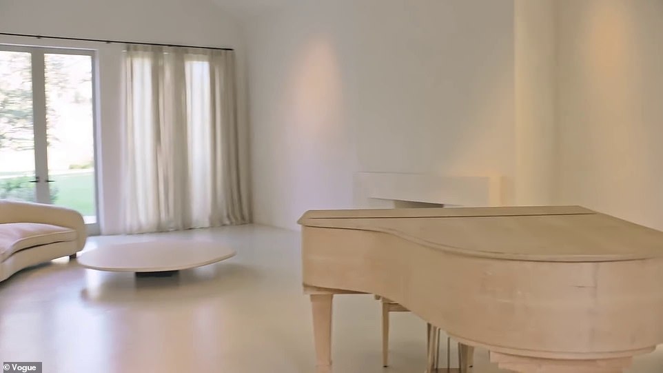 A large white room with a grand piano played by Kim and Kanye's daughter North at the hidden hills home