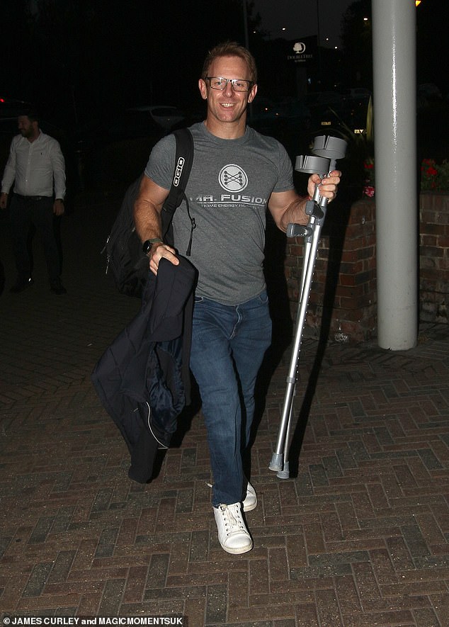 On the move: Back at the hotel after the dress rehearsal, Jody appeared in good spirits as he carried crutches in his hand