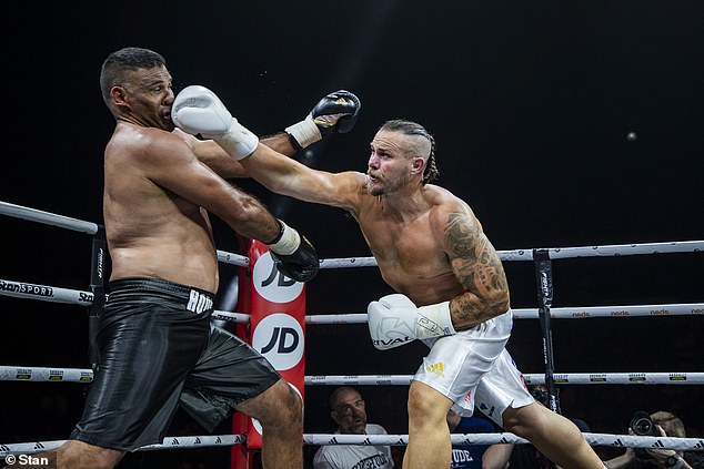 Dragons great Matt Cooper (right) lost to Broncos legend Justin Hodges on points but did himself proud in his first professional fight.