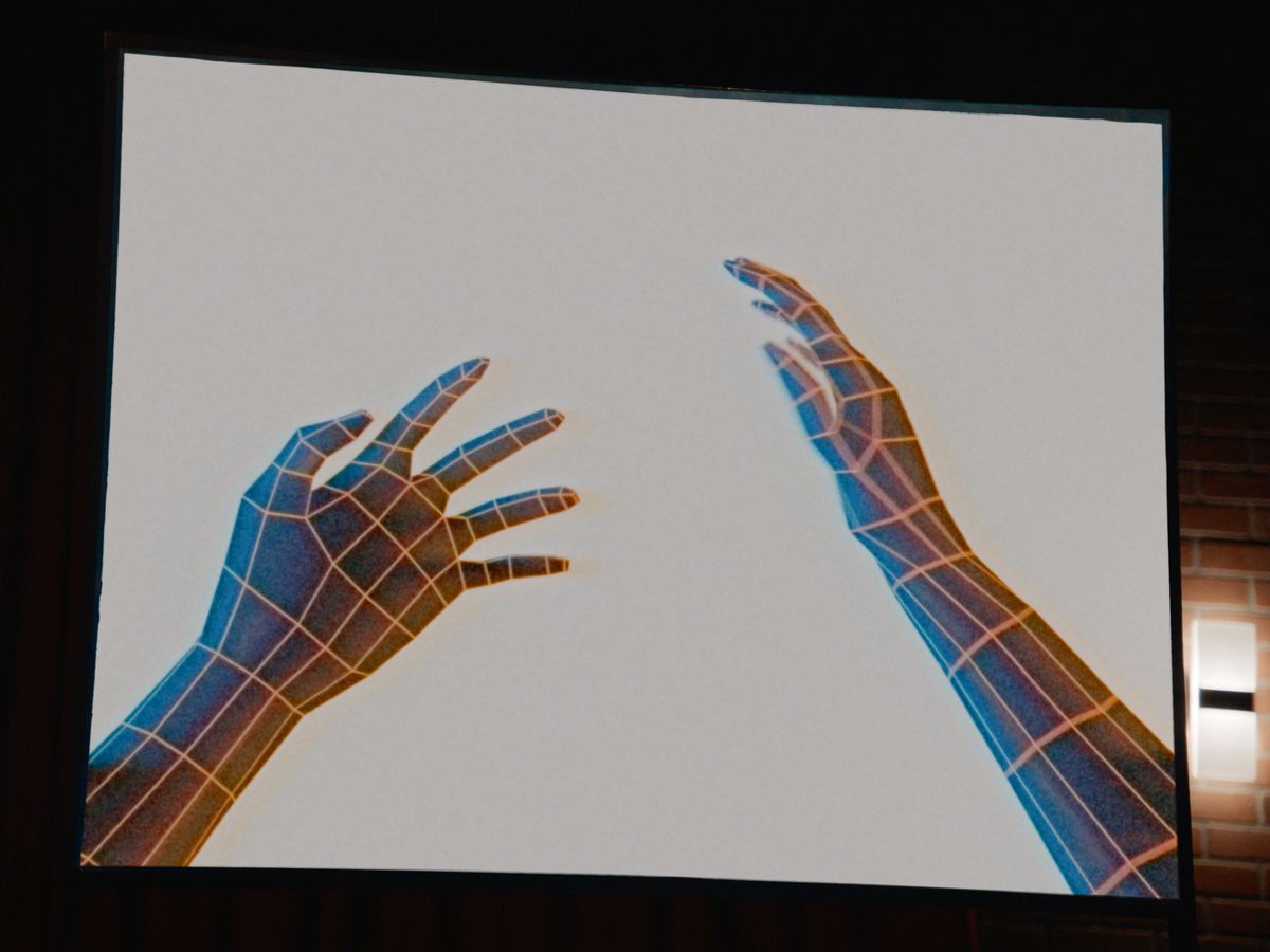 Two simple wireframe hands, extended outwards as if reaching from the side of someone's hand in front of them, in a CG image from segment V/H/S/85 TKNOGD