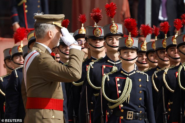 After the Spanish national anthem was played, King Felipe reviewed the troops, walking in front of his daughter