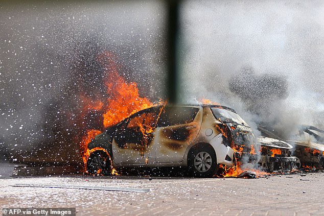 A car burns after a rocket attack in southern Israel on Saturday.  Hamas claimed to have fired 5,000 rockets into the country