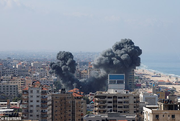 Smoke billows from a building in Gaza after Israel fired missiles in response to Palestinian airstrikes earlier Saturday