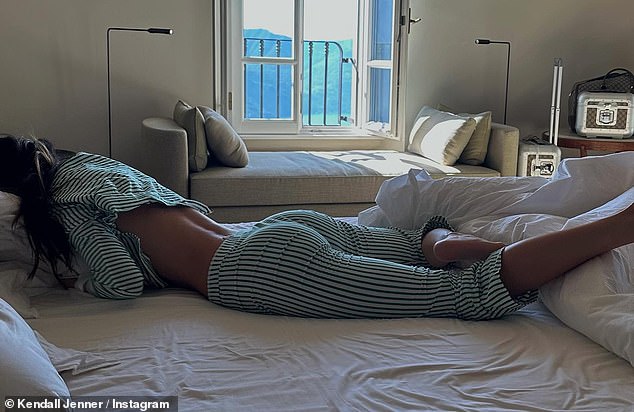 Downtime: Kendall was relaxed in green striped pajamas which showed off her toned bottom as she relaxed on her bed