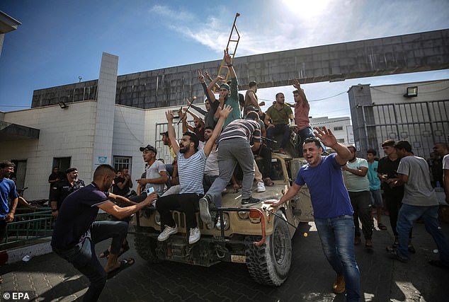 Palestinians drive an Israeli military jeep in the streets of Gaza during the storming of Israeli settlements by the Ezz Al-Din Al Qassam militia, the military wing of Hamas, October 7, 2023