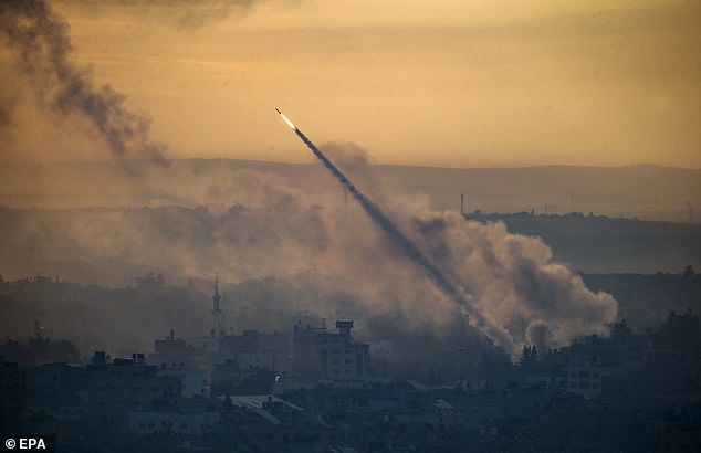 A rocket is fired from the coastal Gaza Strip towards Israel by militants of the Ezz Al-Din Al Qassam militia, the military wing of the Hamas movement, in Gaza City, October 7, 2023