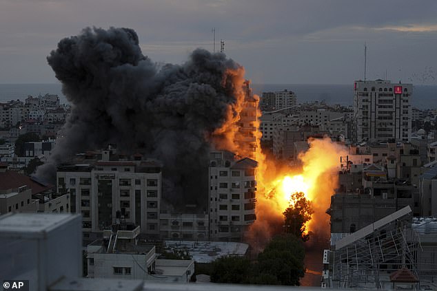 Israel launched a counter-attack.  Pictured: A ball of fire and smoke rises from an explosion on a Palestinian apartment tower after an Israeli airstrike in Gaza City