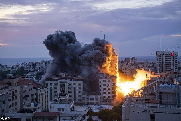 A tower block in Gaza City is hit by an Israeli airstrike after Palestinian militants strike Israel