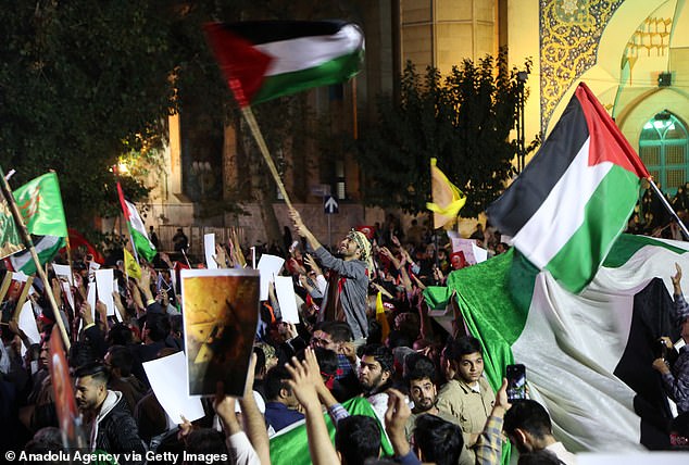 Thousands of Iranians stage a demonstration and carry a Palestinian flag in support of Hamas and the Palestinian Resistance in Tehran, Iran on October 7