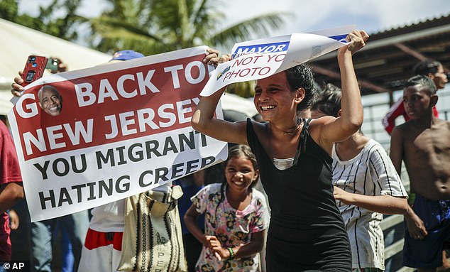 Adams was confronted by protesters during his visit.  One person shouted: 'Shame on you Eric Adams', another person held a sign that said: 'Go back to New Jersey when you hate migrant creeps'