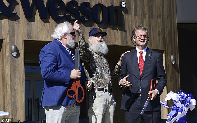 Blount County Mayor Ed Mitchel (left), Si Robertson of Duck Dynasty (center) and Rep.  Tim Burchett (right) helped cut the ribbon at the opening ceremony.  Smith & Wesson chose Tennessee because they wanted to move to a gun-friendly state