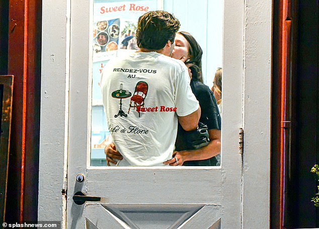 Sealed with a kiss: A couple locked lips at an ice cream shop while waiting for their sweet scoops