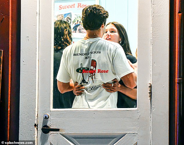 So happy together: The couple couldn't keep their hands off each other as they continued to wait for ice cream on Friday night