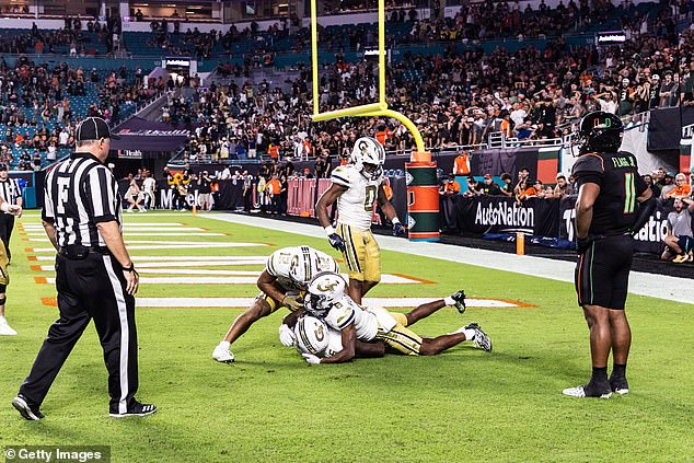 Christian Leary and teammates celebrate after his game-winning touchdown against Miami